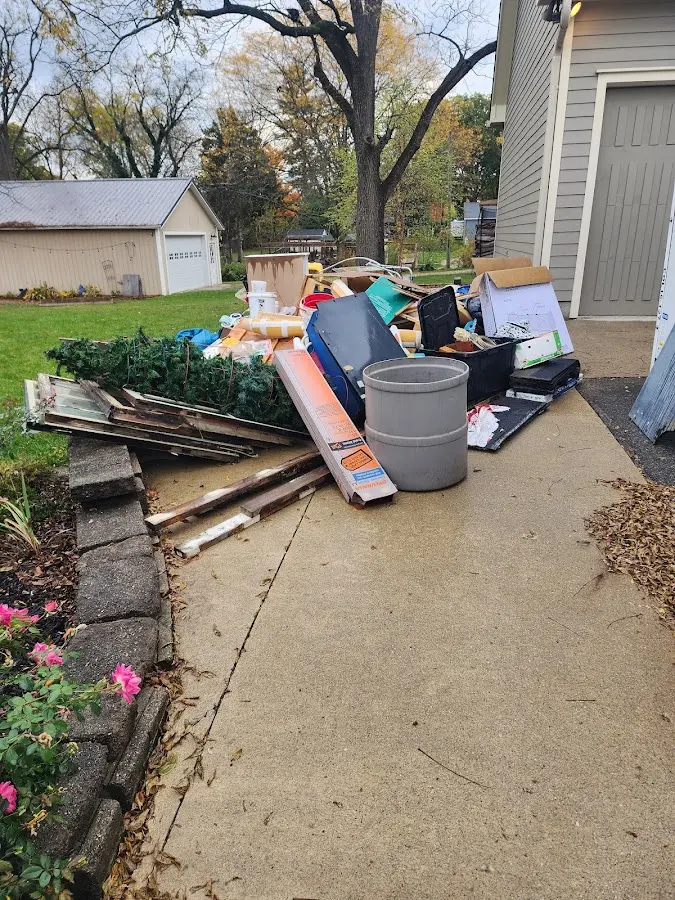 Dumpster being loaded with debris for Estate Cleanout Dumpster Rental in Altamont